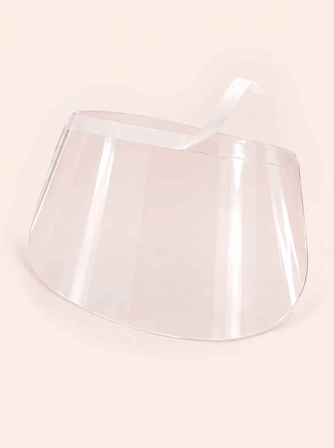 LashCloak transparent curved shield with adhesive strip and partially peeled backing.
